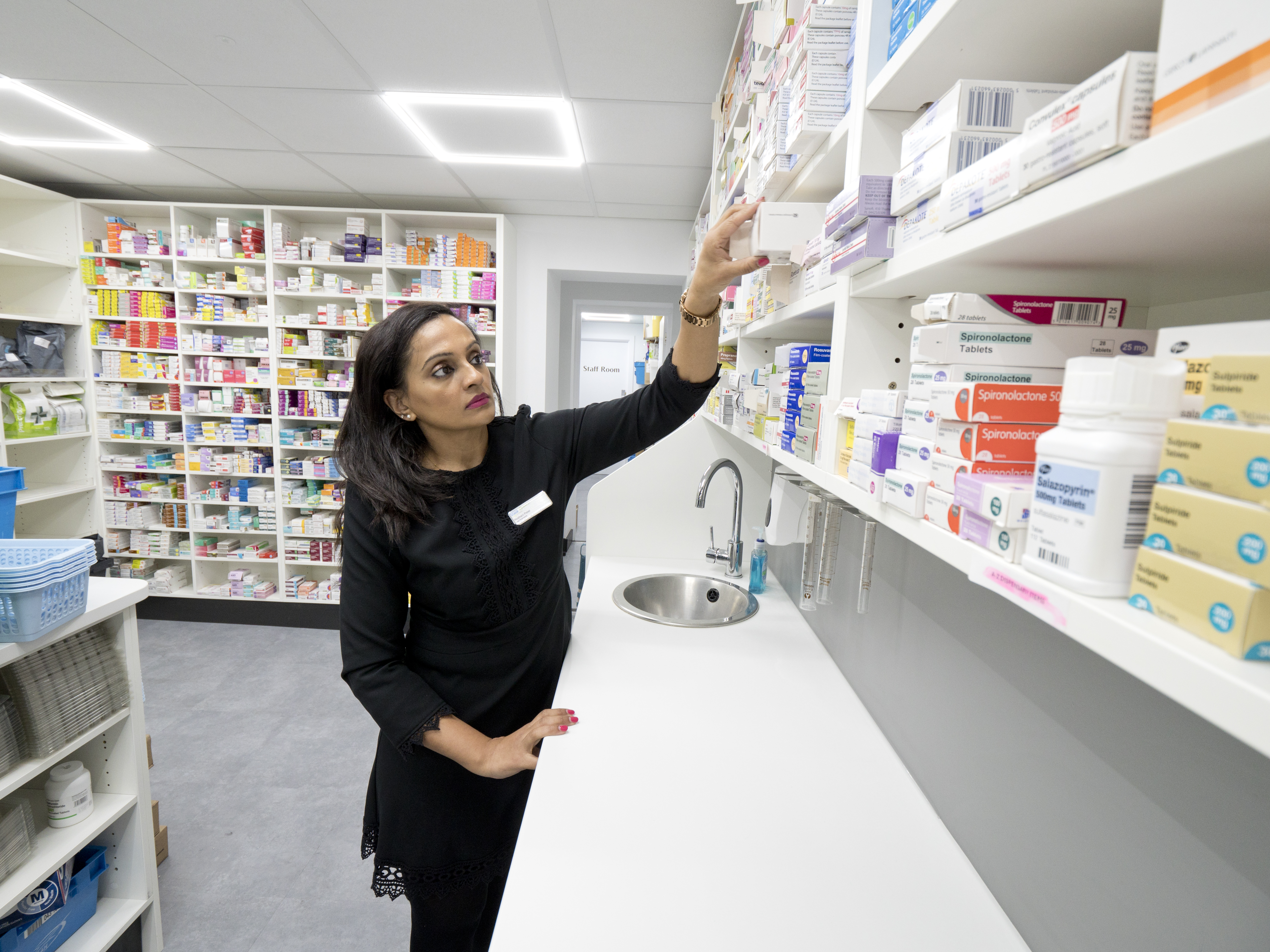 Pharmacist getting item from a dispensary 