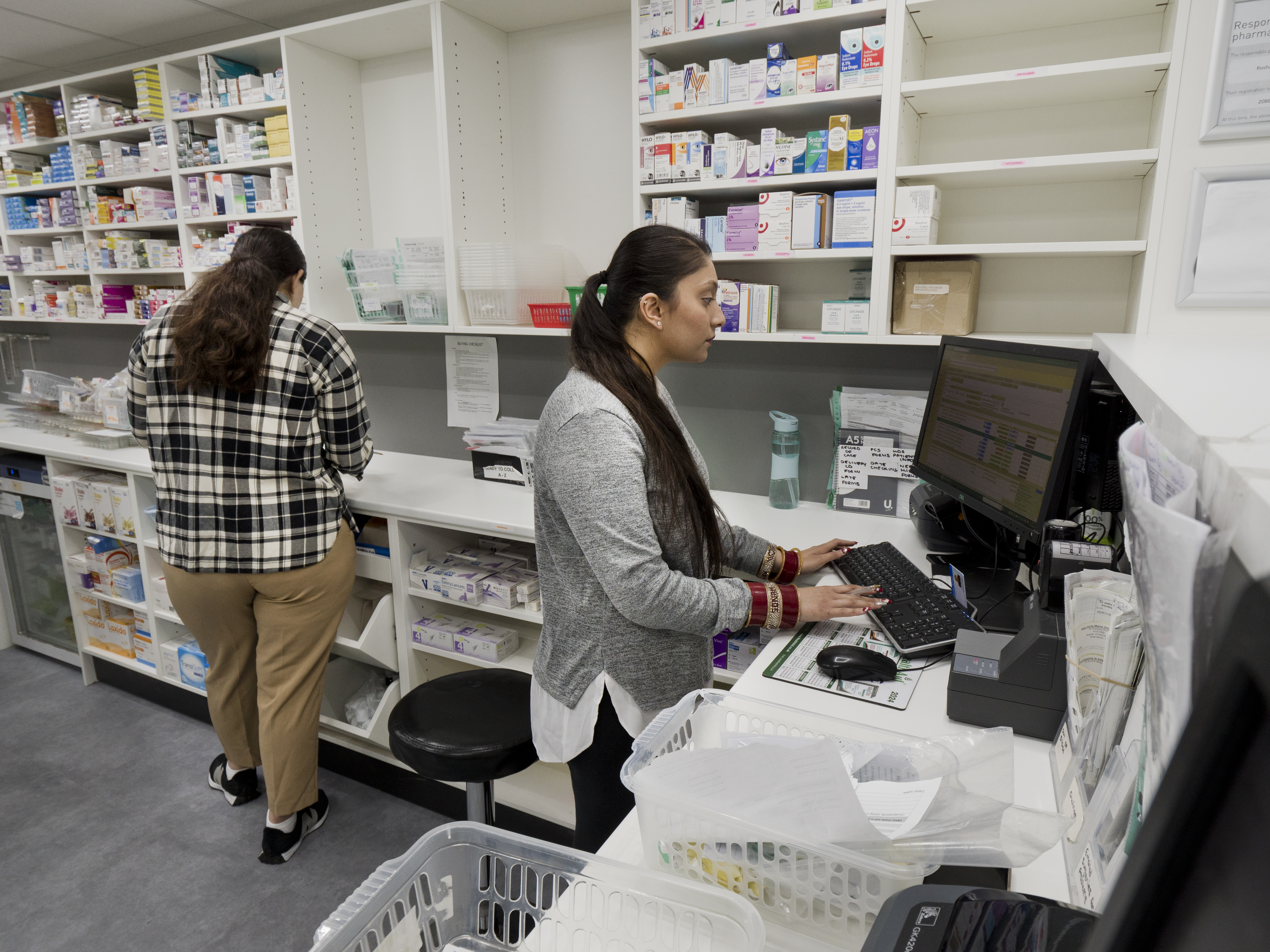 People working in a pharmacy