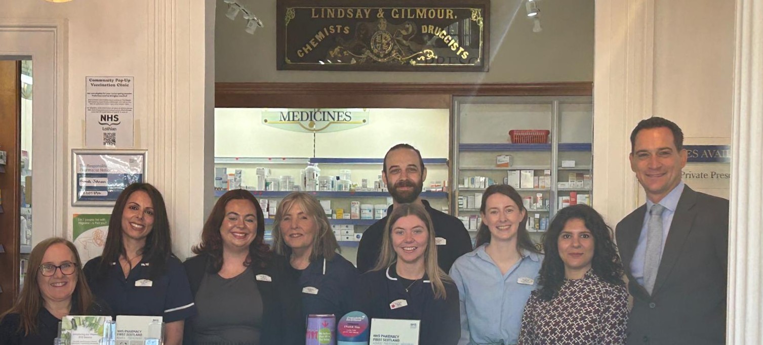 Henry Gregg with staff at a pharmacy in Scotland